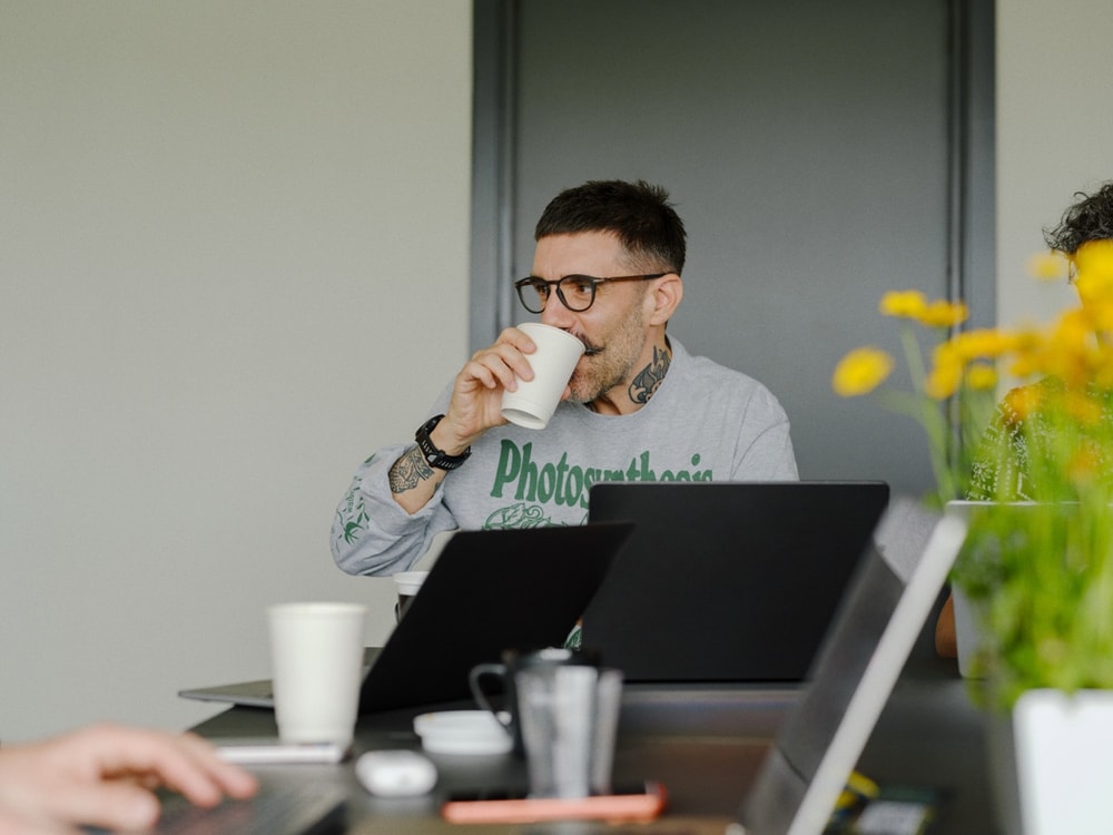A workstation with dual monitors and a morning coffee