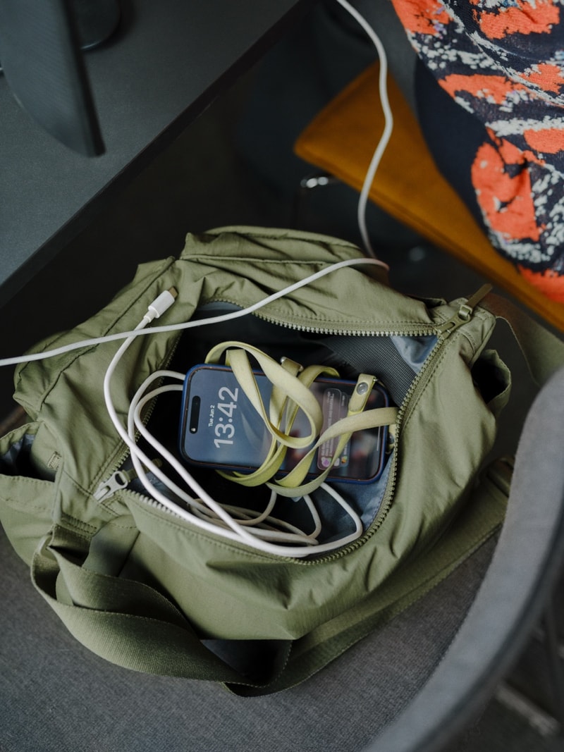 A backpack and charging cables packed for the commute