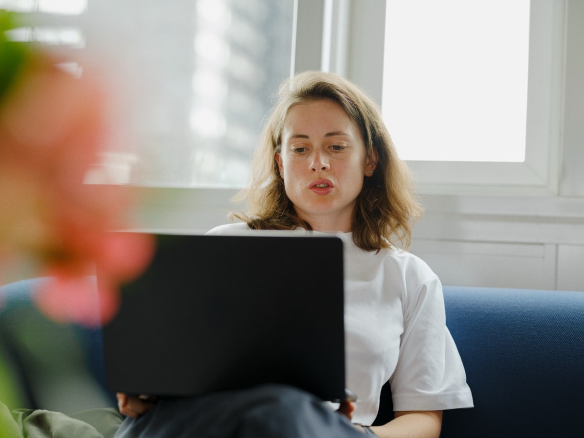 A teammate focused on her laptop at her desk