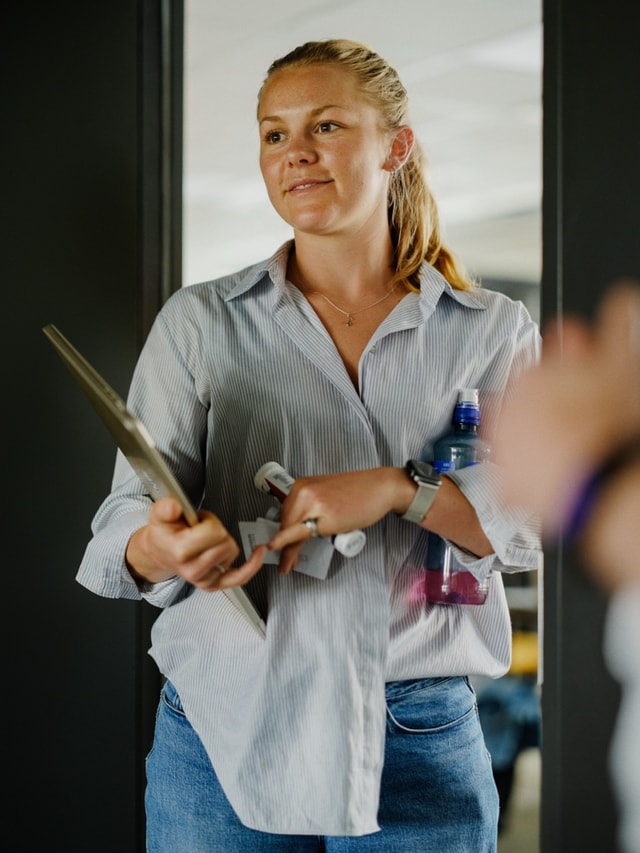 A colleague inspecting a piece of hardware in the light
