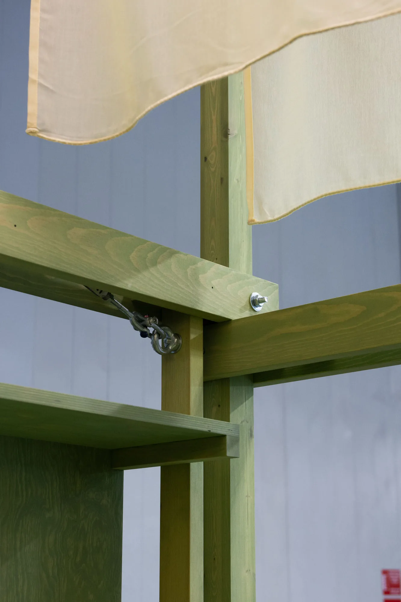 A close-up of the stand’s timber frame and draped canvas canopy